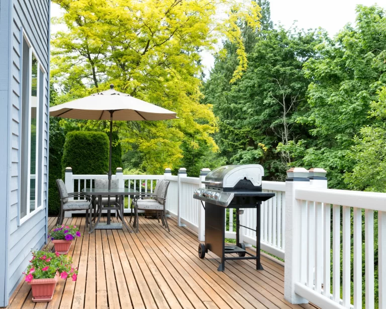 Outdoor dining setup on a wooden sun deck in Surrey